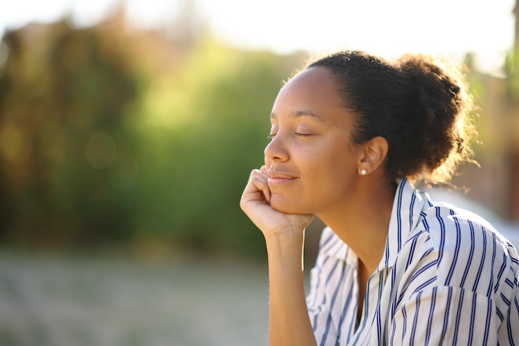 Black relaxed woman resting in a park