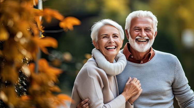 Active seniors taking selfies of them having fun outside in the autumn forest