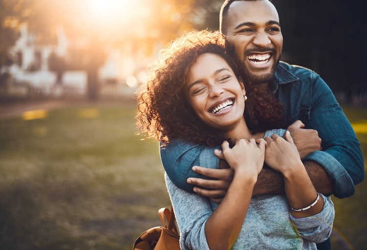 My love is all yours. Shot of an affectionate young couple bonding together outdoors.