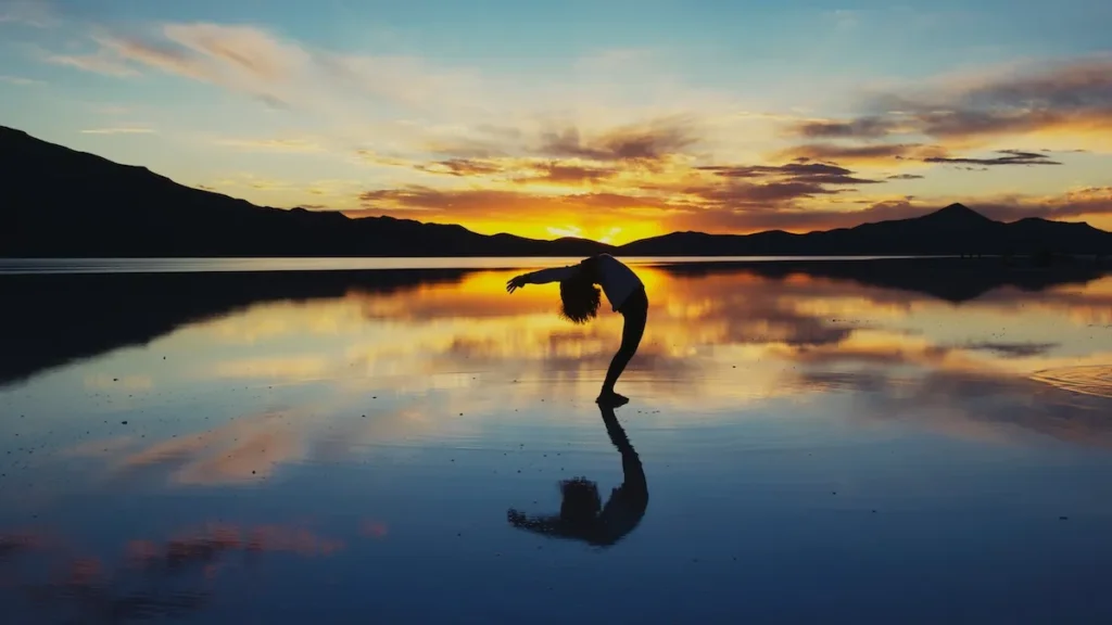 woman exercising in front of sunset
